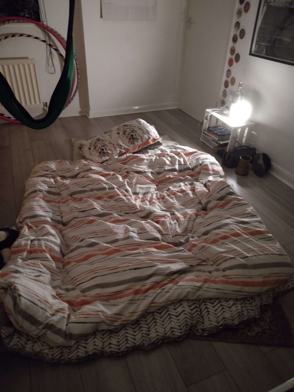 Bed is made up on different quilts on the floor